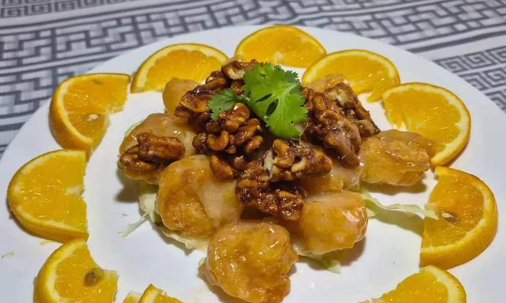 Orange Prawns Succulent prawns glazed with orange sauce, topped with walnuts and garnished with fresh cilantro at Bamboo Cafe, a Chinese Restaurant restaurant in Glendale