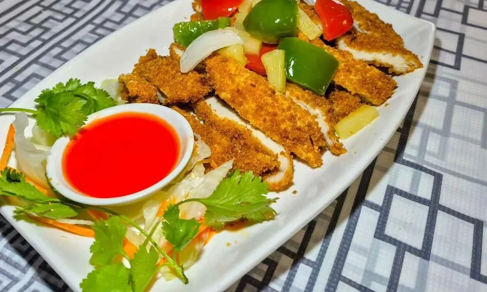 Crispy Chicken Cutlet Golden-brown fried chicken with colorful bell peppers and pineapple at Bamboo Cafe, a Chinese Restaurant restaurant in Glendale