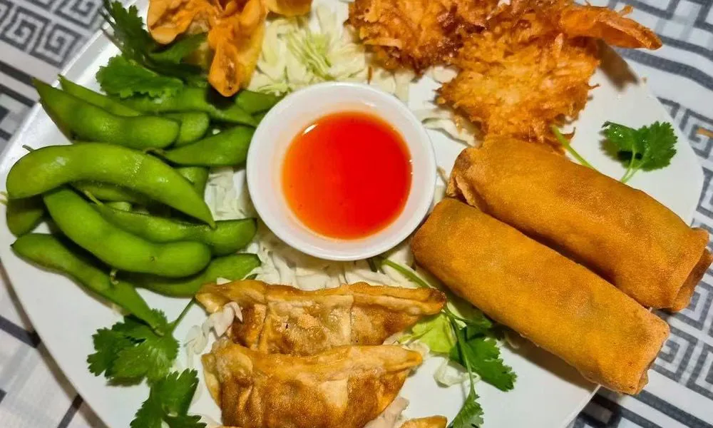Assorted Asian appetizers Fried shrimp, spring rolls, dumplings, edamame, and sauce at Bamboo Cafe, a Chinese Restaurant restaurant in Glendale
