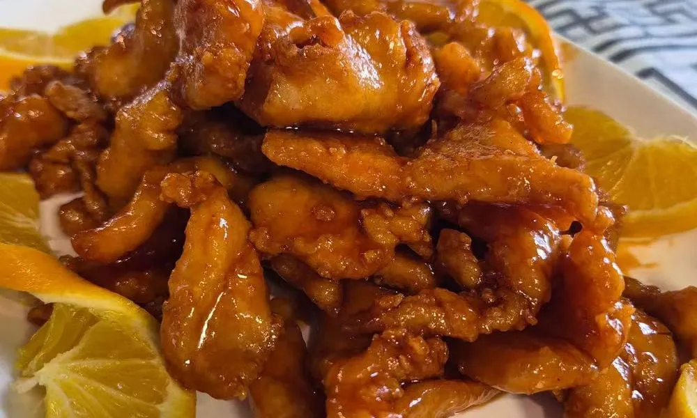 Orange Chicken Succulent chicken pieces glazed with a sweet orange sauce at Bamboo Cafe, a Chinese Restaurant restaurant in Glendale